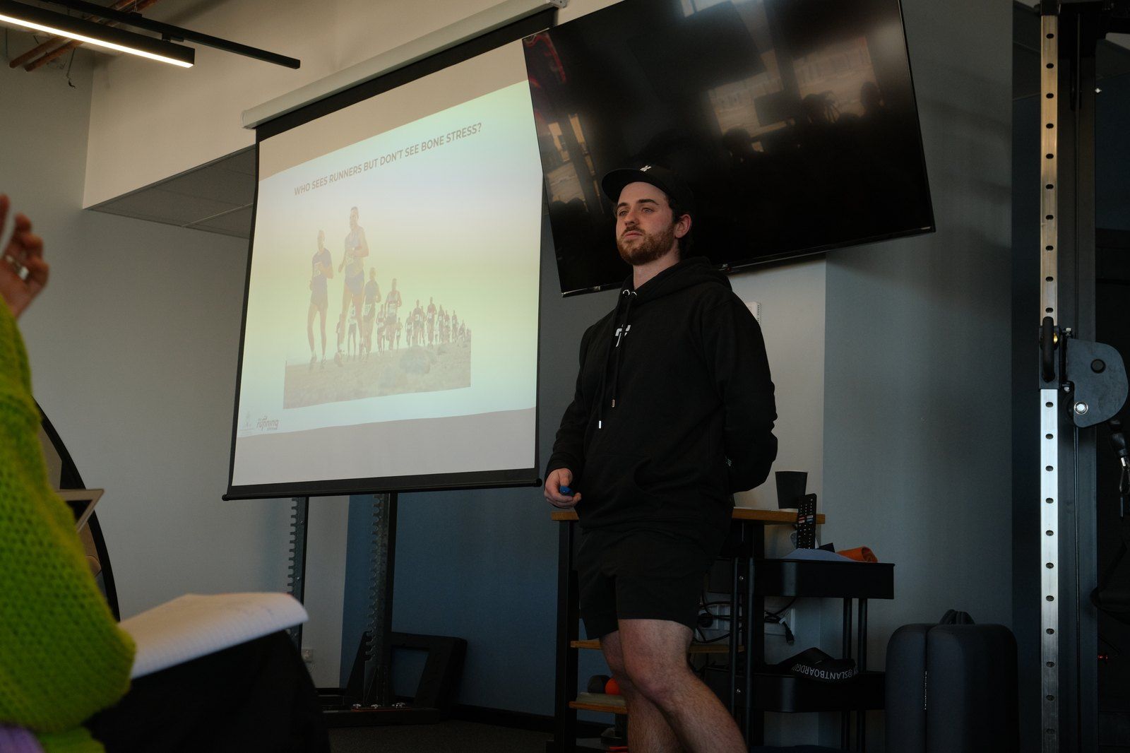 Beau Walker-Tyrrell presenting to clinicians on who sees runners with bone stress